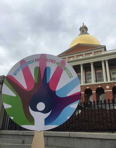 The Rare Disease Day slogan on a paddle given to each attendee, seen in front of the Boston State House.