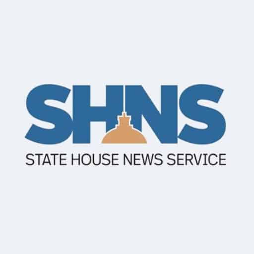 The logo for the State House News Service with features a bold SHNS in blue with a gold depiction of the Massachusetts Statehouse dome.