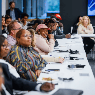 people listening at a u shape table